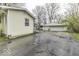 View of the house and detached two-car garage with a driveway and partial fence surrounding the property at 3807 S Olney St, Indianapolis, IN 46237