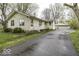 Charming single-story home with a detached garage and an asphalt driveway, perfect for suburban living at 3807 S Olney St, Indianapolis, IN 46237