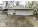 Garage featuring an attached covered car port and private driveway at 3807 S Olney St, Indianapolis, IN 46237