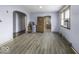 Spacious living room with modern laminate flooring, neutral paint, and ample natural light from the windows at 3807 S Olney St, Indianapolis, IN 46237