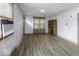 Bright living room featuring laminate floors, a window AC unit, and neutral paint, offering comfort and style at 3807 S Olney St, Indianapolis, IN 46237