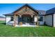 Inviting covered patio with comfortable seating, a grill, and elegant décor, ideal for outdoor entertaining at 413 Cardinal Dr, Jamestown, IN 46147