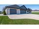 Beautiful white brick home featuring a three-car garage and large, well-maintained lawn at 413 Cardinal Dr, Jamestown, IN 46147