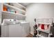 Bright laundry room featuring a washer and dryer, complemented by open shelving for ample storage at 413 Cardinal Dr, Jamestown, IN 46147