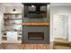 Cozy living room with a modern fireplace, built-in shelving, and stylish decor at 413 Cardinal Dr, Jamestown, IN 46147