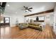 Open-concept living room featuring a comfortable sofa, modern ceiling fan, and wood beam accents at 413 Cardinal Dr, Jamestown, IN 46147