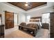 Comfortable main bedroom with tray ceiling, wood accent wall and ensuite bathroom at 413 Cardinal Dr, Jamestown, IN 46147