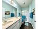 Bathroom with double sinks, a large mirror, and a glass-enclosed shower at 4310 Yarrow Ct, Indianapolis, IN 46237