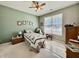 Cozy bedroom featuring a ceiling fan, window with blinds, and comfortable furniture at 4310 Yarrow Ct, Indianapolis, IN 46237