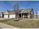 Charming brick home with a manicured lawn, two-car garage, and covered porch at 4310 Yarrow Ct, Indianapolis, IN 46237