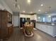 Bright kitchen with white cabinets, granite countertops, and dining area at 4310 Yarrow Ct, Indianapolis, IN 46237