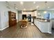 Bright kitchen with white cabinets, granite countertops, and an adjacent dining area at 4310 Yarrow Ct, Indianapolis, IN 46237