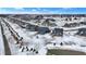 New construction neighborhood showcases homes with modern design, snowy yards, and community spaces at 5461 Oak Knoll Dr, Whitestown, IN 46075