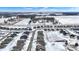 Winter aerial view featuring a neighborhood with cozy homes and a partially frozen pond under a clear blue sky and scattered clouds at 5461 Oak Knoll Dr, Whitestown, IN 46075