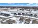 Winter scene of community homes and a frozen pond creating a picturesque landscape, beneath a clear sky with scattered clouds at 5461 Oak Knoll Dr, Whitestown, IN 46075