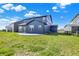 The home features a backyard with a sliding glass door and a concrete patio at 5461 Oak Knoll Dr, Whitestown, IN 46075