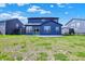 The home features a backyard with a sliding glass door and a concrete patio at 5461 Oak Knoll Dr, Whitestown, IN 46075