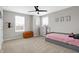 Neutral bedroom with a trundle bed, windows for light, and ceiling fan at 5461 Oak Knoll Dr, Whitestown, IN 46075