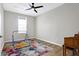 Bright bedroom with a colorful rug, a wood piano, a ceiling fan, and natural light at 5461 Oak Knoll Dr, Whitestown, IN 46075