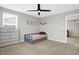 Cozy bedroom with a trundle bed, dresser, and neutral walls at 5461 Oak Knoll Dr, Whitestown, IN 46075