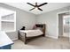 Neutral bedroom with a ceiling fan, wood bed frame, and carpet at 5461 Oak Knoll Dr, Whitestown, IN 46075