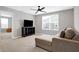 Bonus room featuring a comfortable couch, television, and a ceiling fan at 5461 Oak Knoll Dr, Whitestown, IN 46075