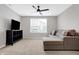 Bonus room featuring a comfortable couch, television, and a ceiling fan at 5461 Oak Knoll Dr, Whitestown, IN 46075