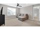 Bonus room featuring a comfortable couch, television, and a ceiling fan at 5461 Oak Knoll Dr, Whitestown, IN 46075