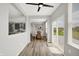 Bright breakfast nook featuring a ceiling fan, sliding glass doors to the patio, and a view of the adjacent kitchen at 5461 Oak Knoll Dr, Whitestown, IN 46075