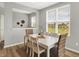 Inviting dining room with a white table, natural accents, and plenty of natural light from the large windows at 5461 Oak Knoll Dr, Whitestown, IN 46075