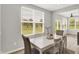 Bright dining room with large windows offering picturesque views of the surrounding landscape at 5461 Oak Knoll Dr, Whitestown, IN 46075