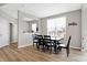 Bright dining room with large windows, hardwood floors and views to an adjacent room at 5461 Oak Knoll Dr, Whitestown, IN 46075