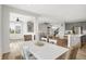 Open-concept dining area flowing into the living room and kitchen, perfect for entertaining at 5461 Oak Knoll Dr, Whitestown, IN 46075