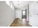 Bright entryway with light gray walls, wood floors, and a view into an adjacent room at 5461 Oak Knoll Dr, Whitestown, IN 46075
