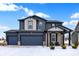 Beautiful two-story home with a three-car garage, stylish accents, and a cozy front porch at 5461 Oak Knoll Dr, Whitestown, IN 46075