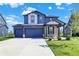Beautiful two-story home with a two car garage, a well-manicured lawn, and attractive curb appeal at 5461 Oak Knoll Dr, Whitestown, IN 46075