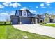 Attractive two-story home featuring a two car garage, a well-manicured lawn, and a long driveway at 5461 Oak Knoll Dr, Whitestown, IN 46075