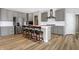 A spacious kitchen with stainless steel appliances, an island, and hardwood floors at 5461 Oak Knoll Dr, Whitestown, IN 46075