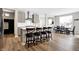 A spacious kitchen with stainless steel appliances, an island, and hardwood floors next to the dining area at 5461 Oak Knoll Dr, Whitestown, IN 46075