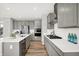 Modern kitchen with gray cabinets, a stainless steel refrigerator, an island, and new appliances with lots of counter space at 5461 Oak Knoll Dr, Whitestown, IN 46075