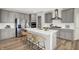 Stylish kitchen showcasing a large island with seating, stainless steel appliances, and gray cabinets and countertops at 5461 Oak Knoll Dr, Whitestown, IN 46075