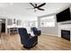 Bright, open-concept living area with a fireplace, TV, and view of the modern kitchen at 5461 Oak Knoll Dr, Whitestown, IN 46075