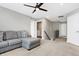 Cozy loft area with plush carpeting, a comfortable couch, and a ceiling fan at 5461 Oak Knoll Dr, Whitestown, IN 46075