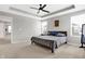 Spacious main bedroom featuring a ceiling fan, large windows, and comfortable carpeting at 5461 Oak Knoll Dr, Whitestown, IN 46075