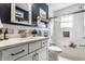 Well-lit bathroom featuring sleek countertops, a soaking tub, and modern fixtures at 5626 Winthrop Ave, Indianapolis, IN 46220