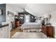 Bright bedroom with a vaulted ceiling, neutral walls, and large window, with stylish furniture at 5626 Winthrop Ave, Indianapolis, IN 46220