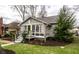 Attractive home with meticulous landscaping and a welcoming front porch perfect for enjoying the outdoors at 5626 Winthrop Ave, Indianapolis, IN 46220