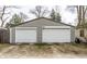 Two-car garage with white doors and gray siding, offering ample parking and storage space at 5626 Winthrop Ave, Indianapolis, IN 46220