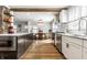 Spacious kitchen with island, stainless steel appliances, and adjacent dining area at 5626 Winthrop Ave, Indianapolis, IN 46220