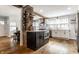 Stylish kitchen featuring a large island with breakfast bar and wine storage at 5626 Winthrop Ave, Indianapolis, IN 46220